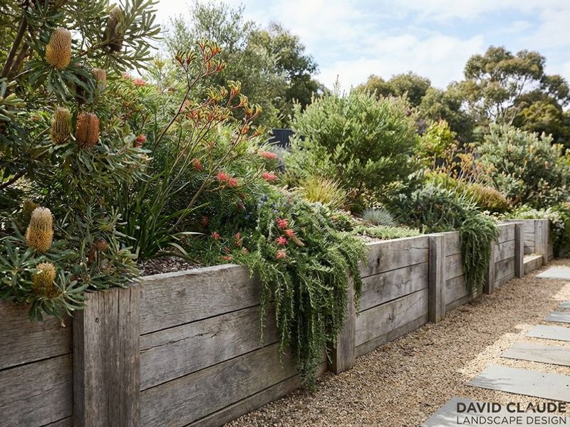 Timber sleeper retaining wall with natural finish
